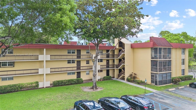 3253 Foxcroft Rd Unit G312, Miramar, FL 33025 - view of building exterior featuring uncovered parking