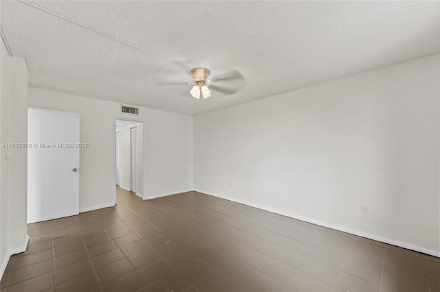 3253 Foxcroft Rd Unit G312, Miramar, FL 33025 - unfurnished room with ceiling fan, dark tile patterned flooring, baseboards, and a textured ceiling
