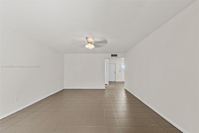 3253 Foxcroft Rd Unit G312, Miramar, FL 33025 - spare room featuring a ceiling fan, a textured ceiling, baseboards, and tile patterned floors