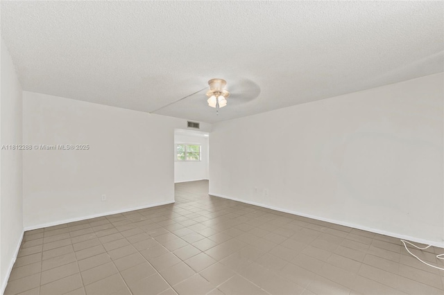 3253 Foxcroft Rd Unit G312, Miramar, FL 33025 - tiled spare room featuring a ceiling fan, a textured ceiling, and baseboards