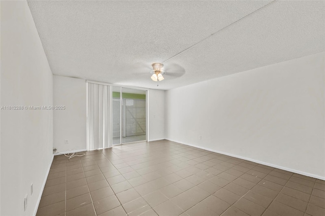 3253 Foxcroft Rd Unit G312, Miramar, FL 33025 - empty room featuring ceiling fan, a textured ceiling, dark tile patterned flooring, and baseboards