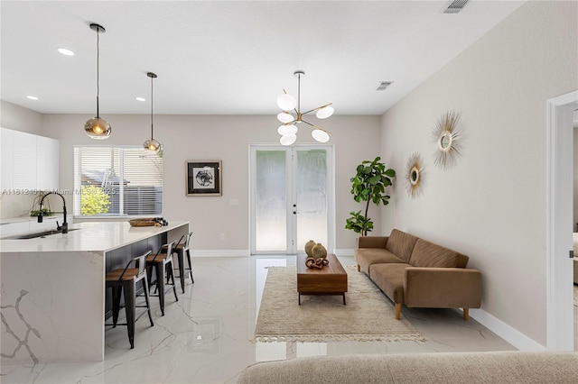 8887 NW 139th Ter, Miami Lakes, FL 33018 - living room with light marble finish flooring, recessed lighting, baseboards, and french doors