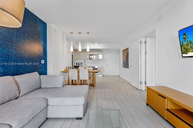 2602 E Hallandale Beach Blvd Unit R1009, Hallandale Beach, FL 33009 - living area featuring light wood-type flooring and track lighting