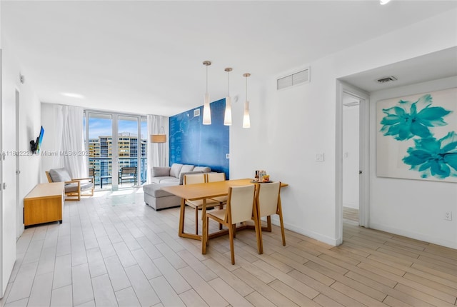 2602 E Hallandale Beach Blvd Unit R1009, Hallandale Beach, FL 33009 - living area featuring floor to ceiling windows, light wood-style flooring, and baseboards