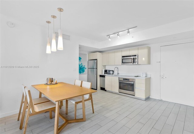 2602 E Hallandale Beach Blvd Unit R1009, Hallandale Beach, FL 33009 - kitchen featuring stainless steel appliances, light countertops, a sink, hanging light fixtures, and baseboards