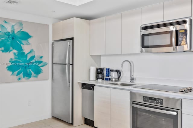 2602 E Hallandale Beach Blvd Unit R1009, Hallandale Beach, FL 33009 - kitchen featuring stainless steel appliances, a sink, light countertops, and modern cabinets