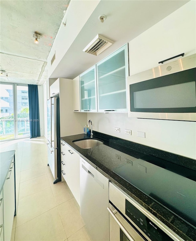 3470 E Coast Ave Unit H1006, Miami, FL 33137 - kitchen with a sink, stainless steel appliances, white cabinetry, and dark stone countertops