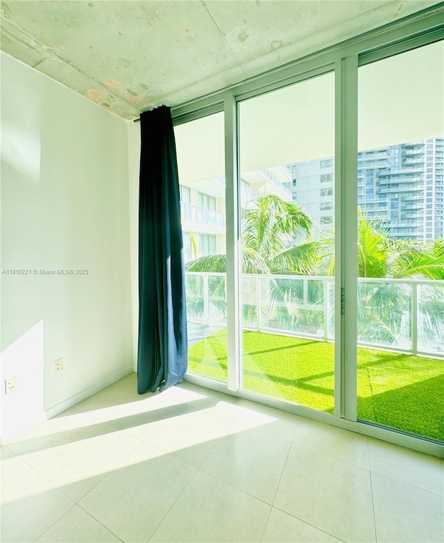 3470 E Coast Ave Unit H1006, Miami, FL 33137 - unfurnished room with a wall of windows