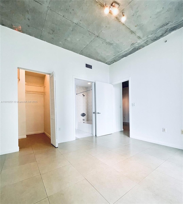 3470 E Coast Ave Unit H1006, Miami, FL 33137 - unfurnished bedroom with a closet, a spacious closet, tile patterned flooring, and ensuite bathroom