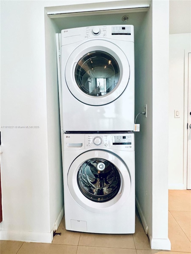 3470 E Coast Ave Unit H1006, Miami, FL 33137 - laundry area featuring estacked washer and dryer, light tile patterned floors, and baseboards