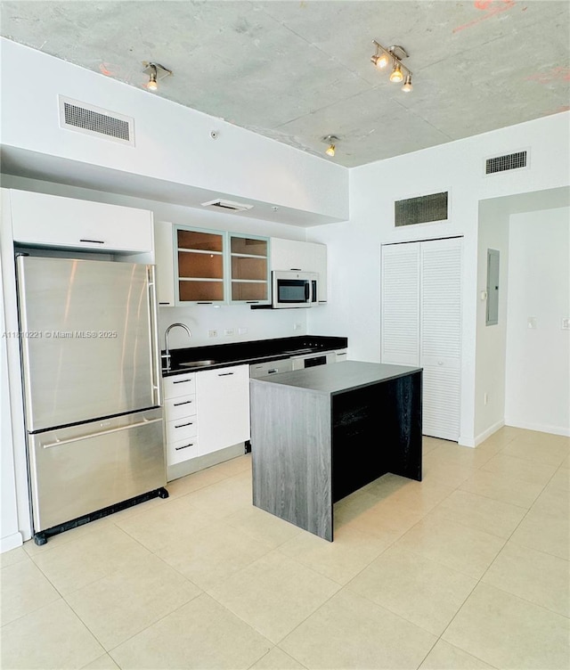 3470 E Coast Ave Unit H1006, Miami, FL 33137 - kitchen with freestanding refrigerator, a sink, modern cabinets, electric panel, and a center island
