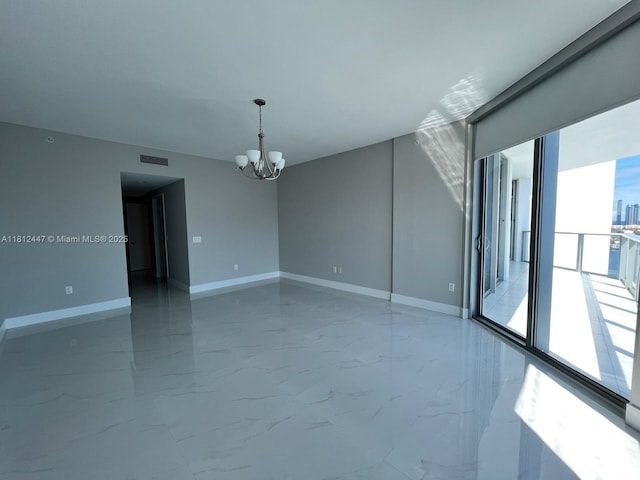 17301 Biscayne Blvd Unit 2105, North Miami Beach, FL 33160 - spare room with a chandelier, marble finish flooring, and baseboards