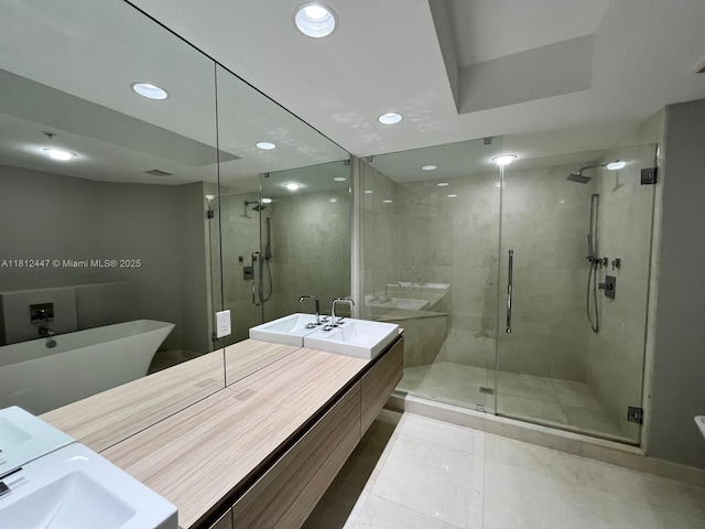 17301 Biscayne Blvd Unit 2105, North Miami Beach, FL 33160 - bathroom featuring vanity, a shower stall, a soaking tub, and recessed lighting