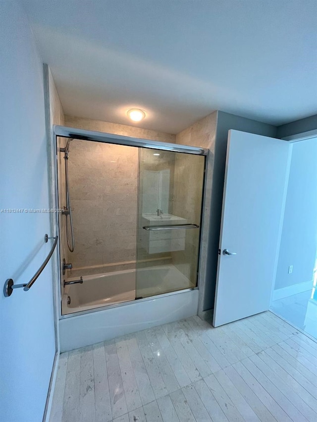 17301 Biscayne Blvd Unit 2105, North Miami Beach, FL 33160 - full bath featuring shower / bath combination with glass door and wood finished floors