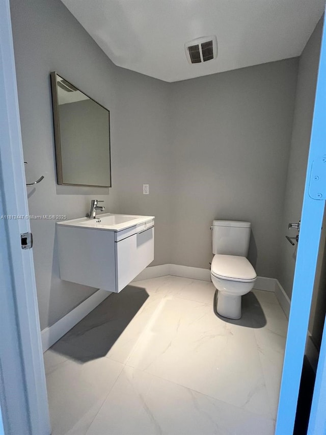 17301 Biscayne Blvd Unit 2105, North Miami Beach, FL 33160 - bathroom featuring toilet, vanity, baseboards, and marble finish floors