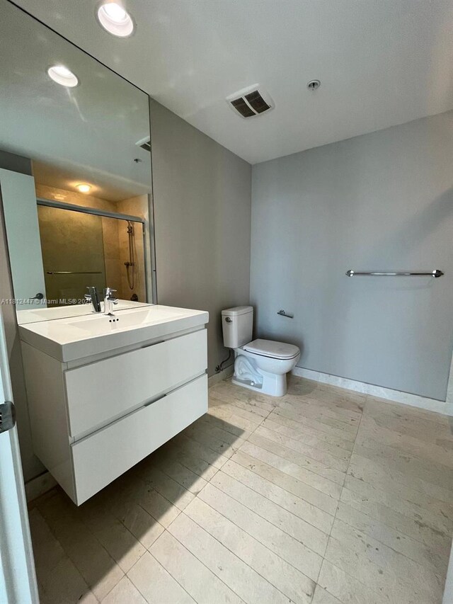 17301 Biscayne Blvd Unit 2105, North Miami Beach, FL 33160 - bathroom with vanity, a shower with shower door, toilet, recessed lighting, and baseboards
