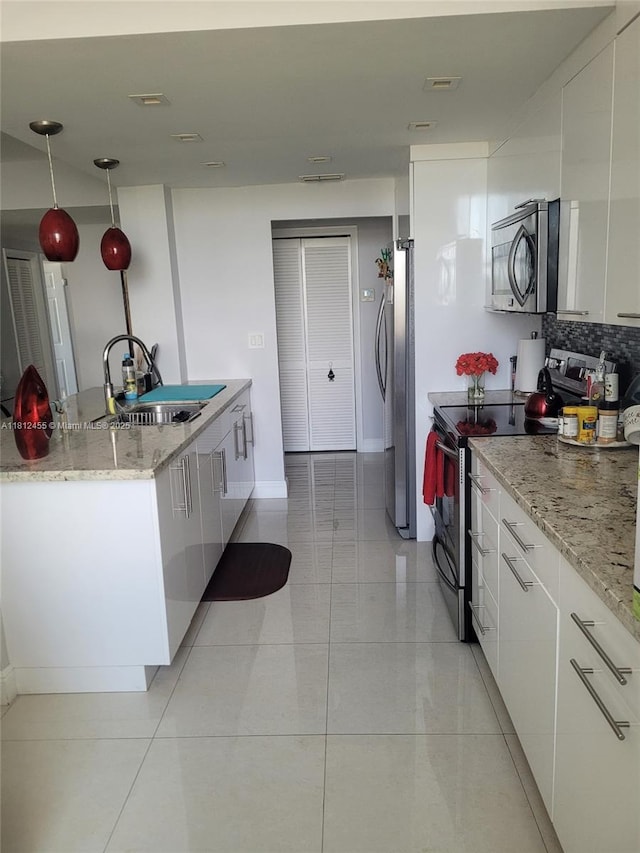 4330 Hillcrest Dr Unit 619, Hollywood, FL 33021 - kitchen featuring stainless steel appliances, modern cabinets, white cabinetry, and backsplash