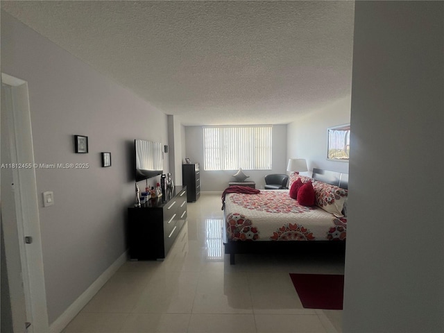 4330 Hillcrest Dr Unit 619, Hollywood, FL 33021 - bedroom with baseboards, light tile patterned flooring, and a textured ceiling