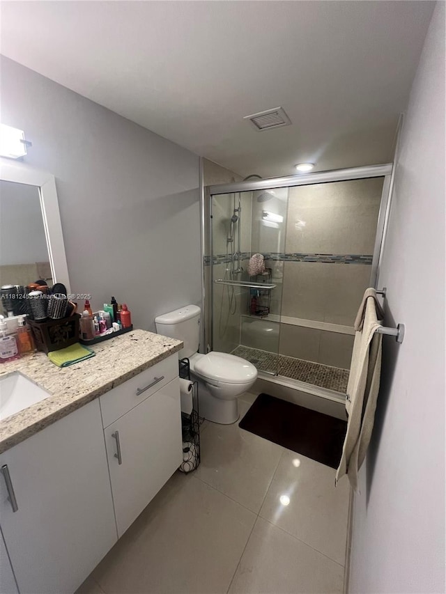 4330 Hillcrest Dr Unit 619, Hollywood, FL 33021 - bathroom featuring vanity, toilet, a shower stall, and tile patterned flooring