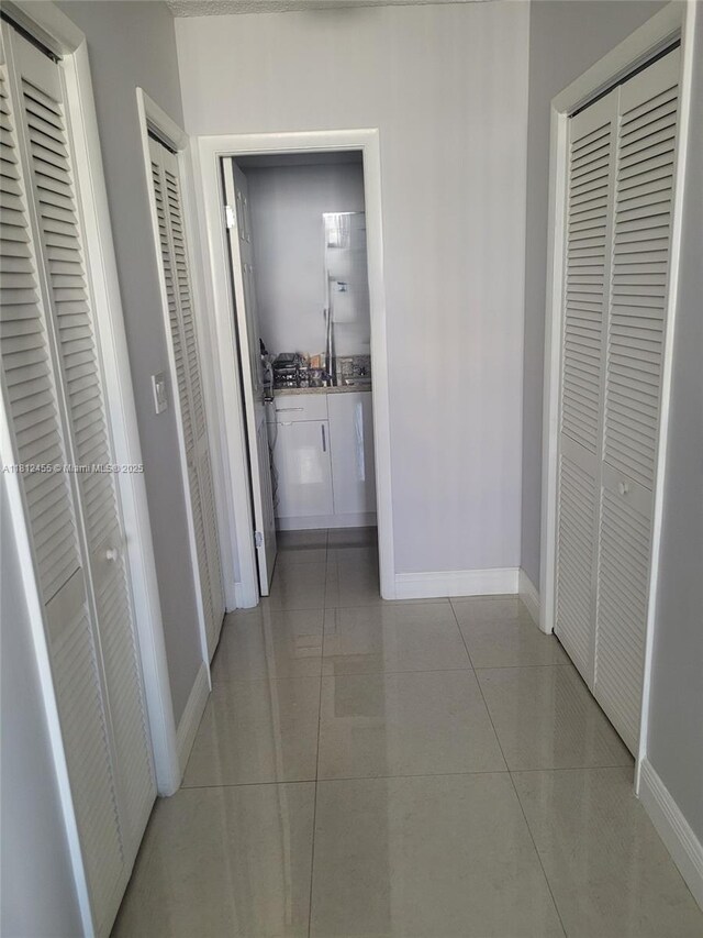 4330 Hillcrest Dr Unit 619, Hollywood, FL 33021 - hallway featuring baseboards and light tile patterned floors