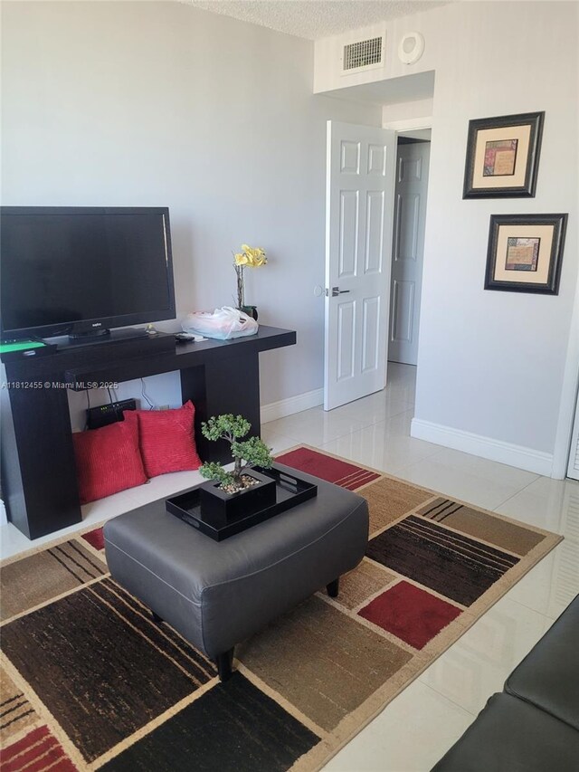 4330 Hillcrest Dr Unit 619, Hollywood, FL 33021 - tiled living room with baseboards and a textured ceiling