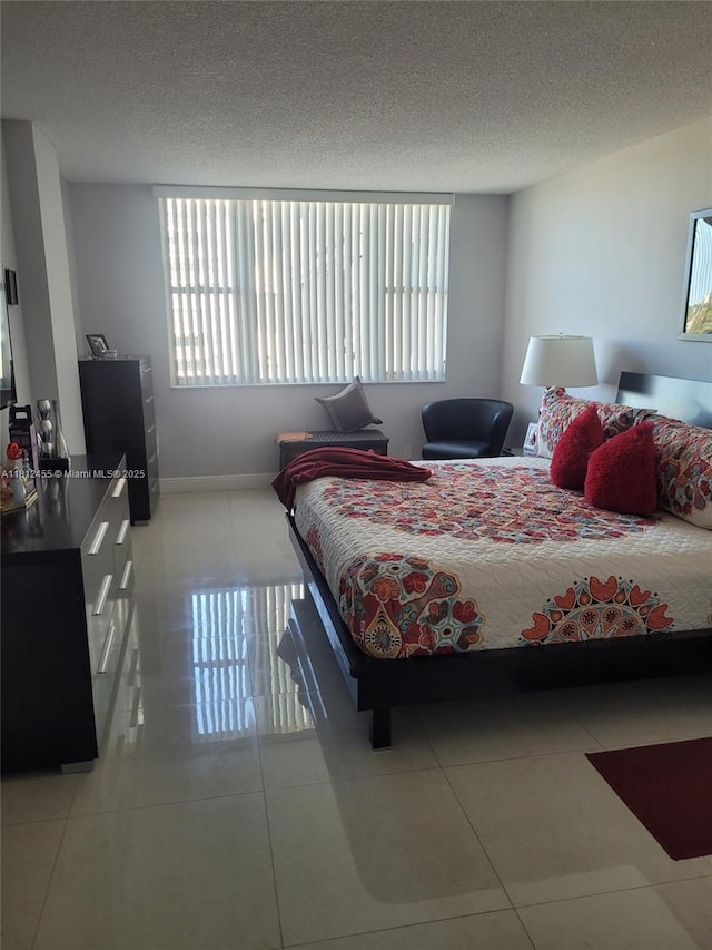 4330 Hillcrest Dr Unit 619, Hollywood, FL 33021 - bedroom featuring light tile patterned flooring, multiple windows, and a textured ceiling