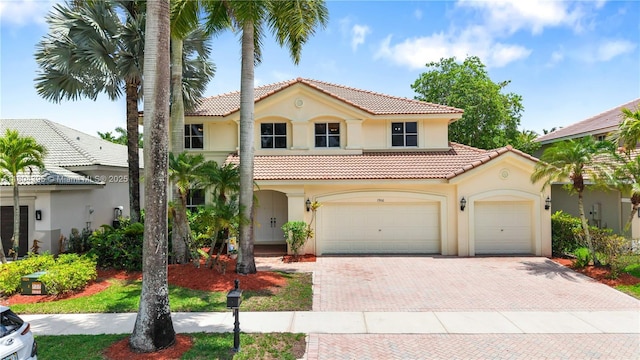 1906 Timberline Rd, Weston, FL 33327 - mediterranean / spanish-style house featuring stucco siding, a tiled roof, and decorative driveway