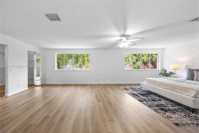 1906 Timberline Rd, Weston, FL 33327 - bedroom with light wood finished floors, multiple windows, baseboards, and ceiling fan