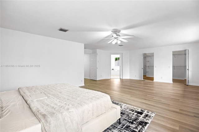1906 Timberline Rd, Weston, FL 33327 - bedroom with wood finished floors, baseboards, a ceiling fan, and a walk in closet