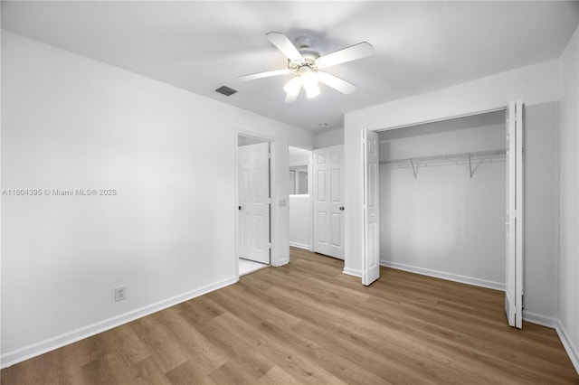 1906 Timberline Rd, Weston, FL 33327 - unfurnished bedroom featuring baseboards, wood finished floors, a closet, and a ceiling fan
