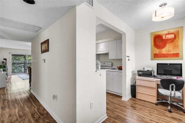 801 SW 138th Ave Unit 404E, Pembroke Pines, FL 33027 - hallway with attic access, wood finished floors, a textured ceiling, baseboards, and a desk