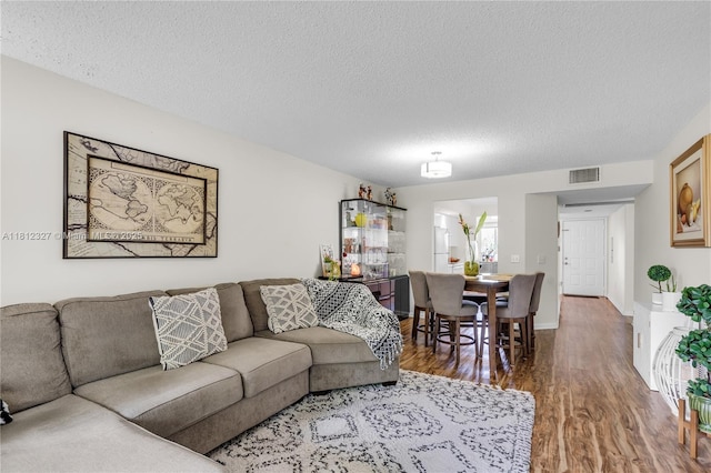 801 SW 138th Ave Unit 404E, Pembroke Pines, FL 33027 - living room with wood finished floors and a textured ceiling