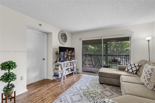 801 SW 138th Ave Unit 404E, Pembroke Pines, FL 33027 - living room featuring wood finished floors, a textured ceiling, and baseboards
