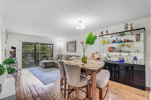801 SW 138th Ave Unit 404E, Pembroke Pines, FL 33027 - dining area with wood finished floors and a textured ceiling
