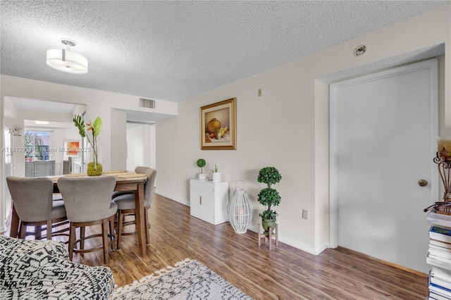 801 SW 138th Ave Unit 404E, Pembroke Pines, FL 33027 - dining space with a textured ceiling, wood finished floors, and baseboards