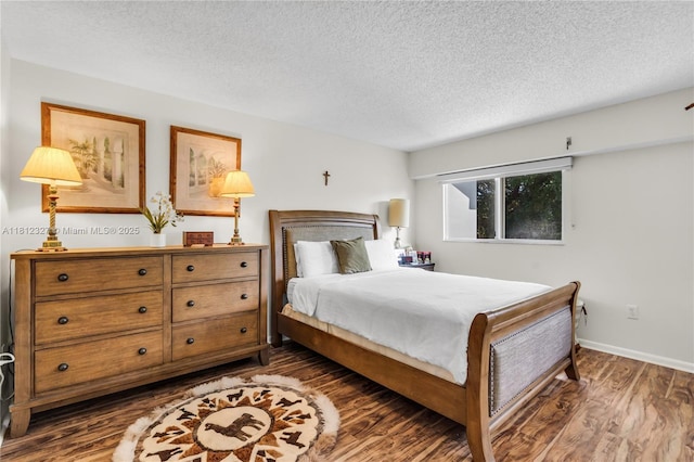 801 SW 138th Ave Unit 404E, Pembroke Pines, FL 33027 - bedroom featuring dark wood-type flooring, a textured ceiling, and baseboards