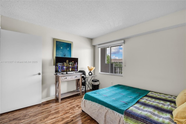801 SW 138th Ave Unit 404E, Pembroke Pines, FL 33027 - bedroom featuring wood finished floors and a textured ceiling