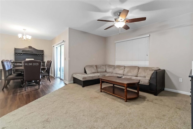 1070 Swiss Pointe Ln, Rockledge, FL 32955 - living room featuring a chandelier, a ceiling fan, baseboards, and wood finished floors