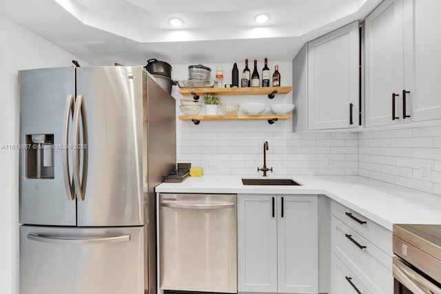 5701 Collins Ave Unit 712, Miami Beach, FL 33140 - kitchen with appliances with stainless steel finishes, a sink, backsplash, recessed lighting, and light countertops