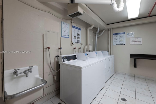 5701 Collins Ave Unit 712, Miami Beach, FL 33140 - communal laundry room featuring independent washer and dryer and light tile patterned floors