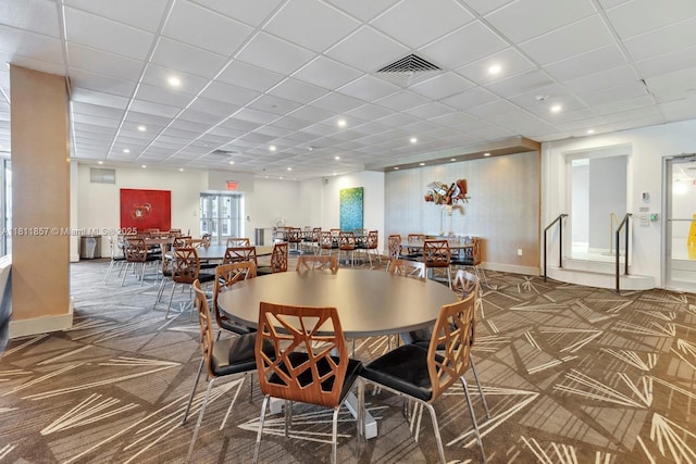 5701 Collins Ave Unit 712, Miami Beach, FL 33140 - dining room featuring carpet floors, baseboards, and a paneled ceiling