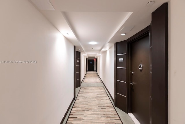 5701 Collins Ave Unit 712, Miami Beach, FL 33140 - hallway with baseboards, light wood-style flooring, and recessed lighting
