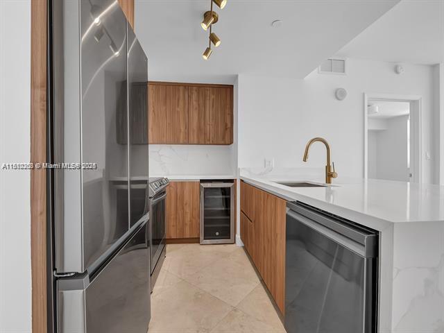 4100 Salzedo St Unit 901, Coral Gables, FL 33146 - kitchen with stainless steel appliances, wine cooler, modern cabinets, and a sink