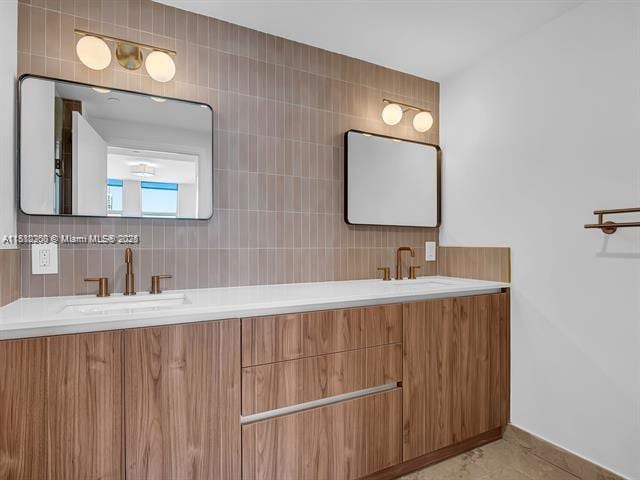 4100 Salzedo St Unit 901, Coral Gables, FL 33146 - bathroom featuring double vanity, tasteful backsplash, and baseboards