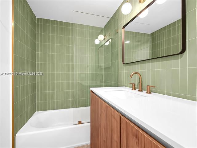 4100 Salzedo St Unit 901, Coral Gables, FL 33146 - full bathroom featuring tile walls, vanity, and shower / bath combination