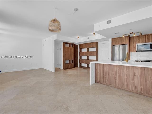 4100 Salzedo St Unit 901, Coral Gables, FL 33146 - kitchen featuring stainless steel appliances, light countertops, open floor plan, modern cabinets, and baseboards