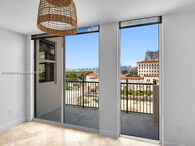 4100 Salzedo St Unit 901, Coral Gables, FL 33146 - entryway with a wall of windows, baseboards, and tile patterned floors