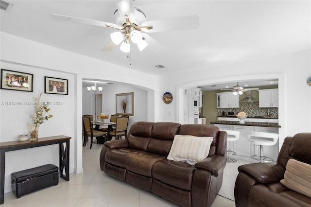 10421 NW 21st St, Pembroke Pines, FL 33026 - living area featuring a ceiling fan, arched walkways, light tile patterned floors, and a chandelier