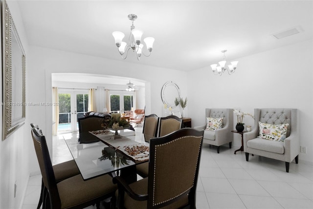10421 NW 21st St, Pembroke Pines, FL 33026 - dining space featuring a chandelier, arched walkways, light tile patterned floors, and french doors