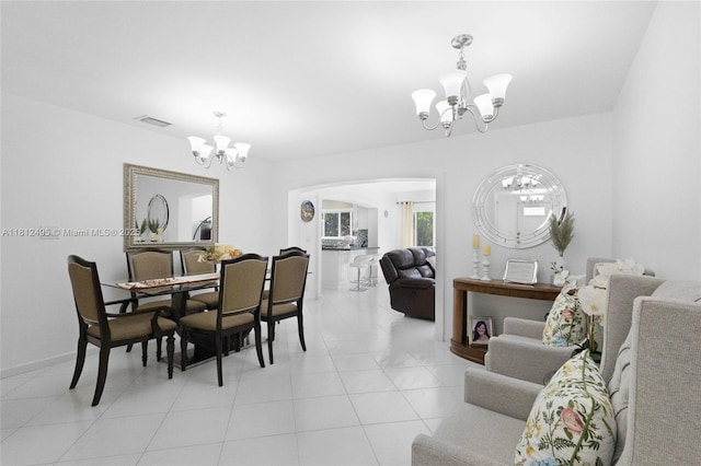 10421 NW 21st St, Pembroke Pines, FL 33026 - dining area with a chandelier, arched walkways, light tile patterned flooring, and baseboards